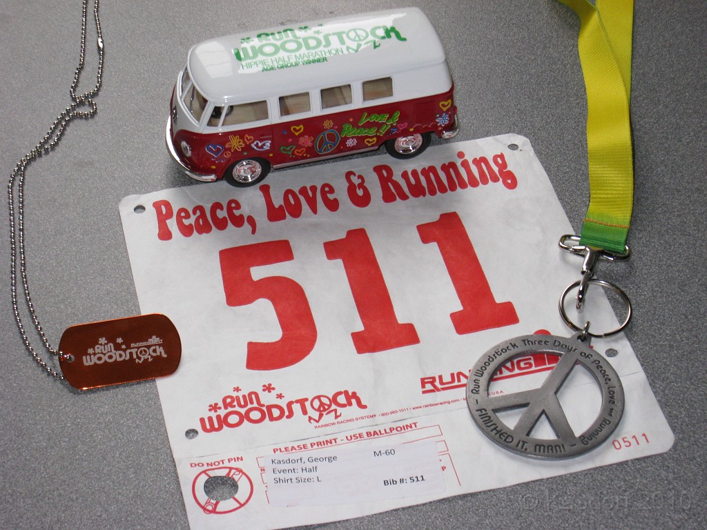 Woodstock HM 2010 011.JPG - The age group award (the micro bus) for finishing second in the 60-64 group. Also the finishers (peace) medal (Man!) and a dog tag they gave out as part of the "wounded warrior" sponsorship)